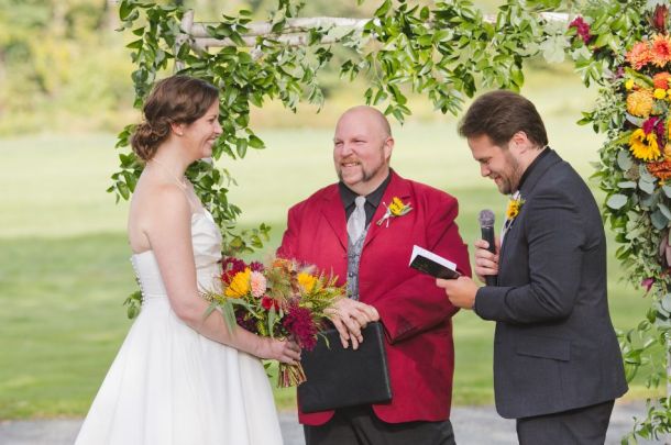 Groom reads his vows to his bride as Pierre, in his roll as an ordained minister, looks on.