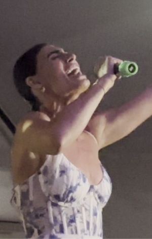 Woman singing at a karaoke show.